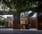 Modern wood and glass library - a space designed like a bookcase that absorbs visitors