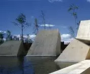 Architectural skylights piercing through the plane of water - elements that illuminate underground spaces and introduce the symbolism of the 