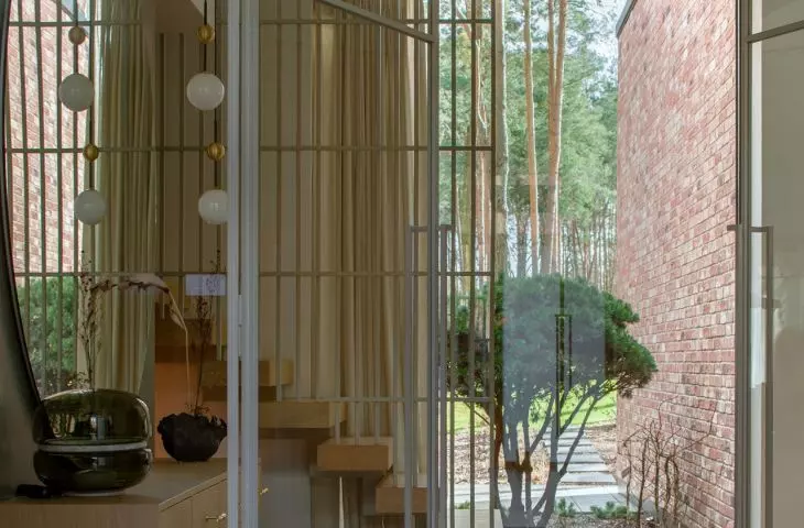 The subtle color palette harmonizes with the surrounding landscape, emphasizing the organic character of the space