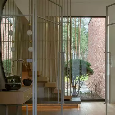 The subtle color palette harmonizes with the surrounding landscape, emphasizing the organic character of the space