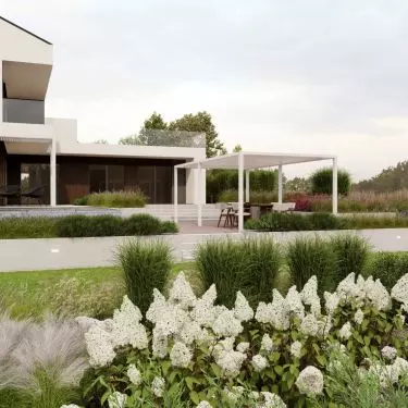 Modern body of the house against the background of a green garden