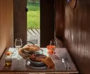 in the wall behind the bed is hidden an opening table