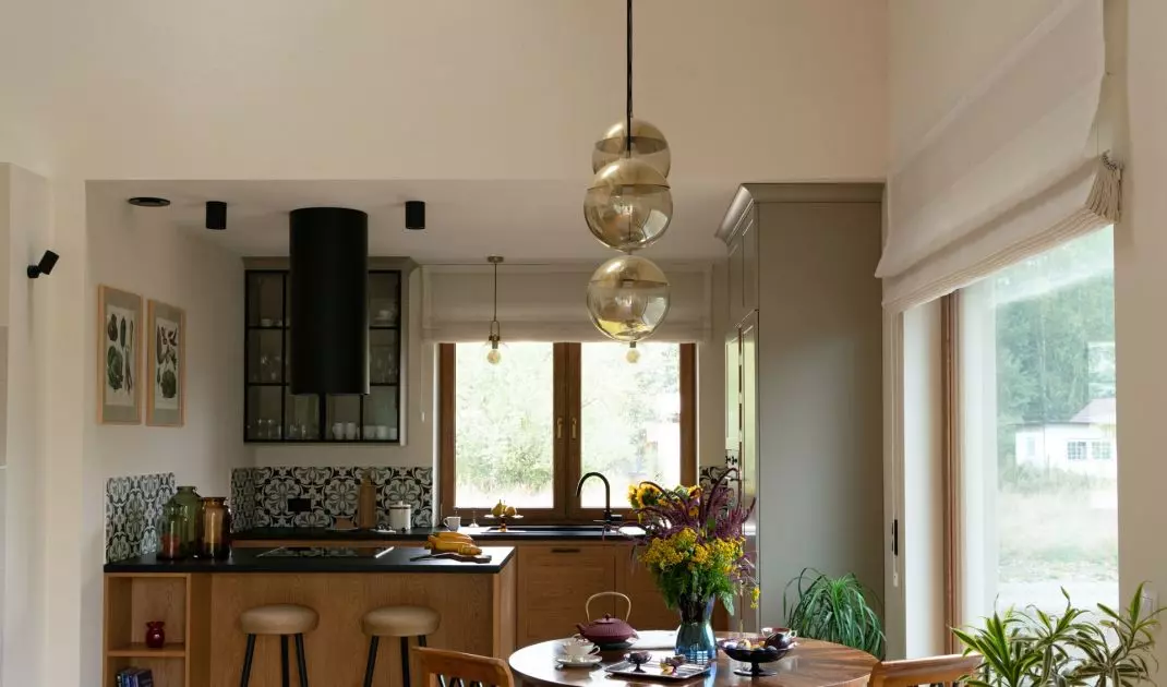 The living room, with its high ceiling, is an open space where wooden beams and bright light invite you to relax in an idyllic setting