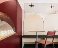 Plywood furniture warms up the interior of an ice cream shop
