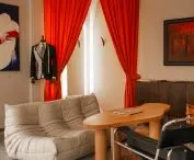 A fitting room hidden behind a red theatrical curtain