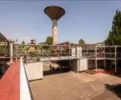 located under the characteristic water tower, the container town directly refers to the industrial history of the place