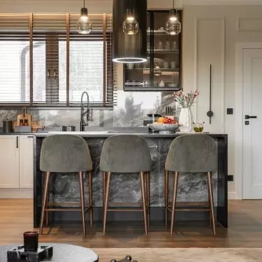 The kitchen is spacious, and the Cosentino natural granite island has become a meeting place