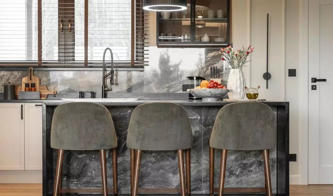 The kitchen is spacious, and the Cosentino natural granite island has become a meeting place
