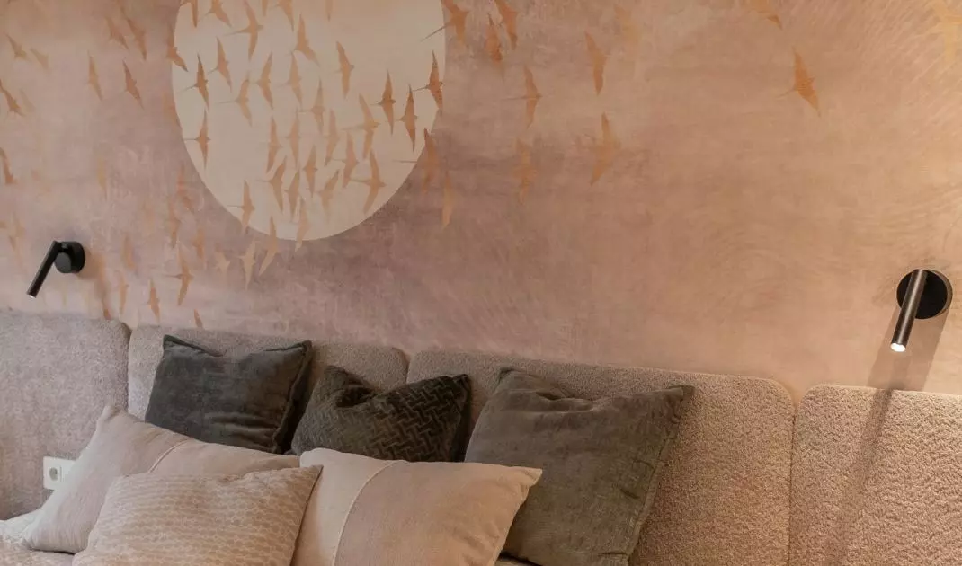 In the bedroom behind the bed there is wallpaper 