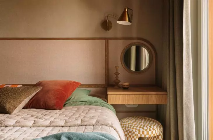 The bedroom is dominated by greenery - calm, relaxing - contrasted with the warm red ceiling