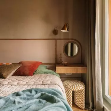 The bedroom is dominated by greenery - calm, relaxing - contrasted with the warm red ceiling