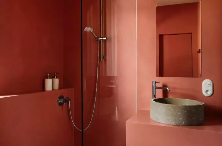 The bathroom is kept in a uniform terracotta color