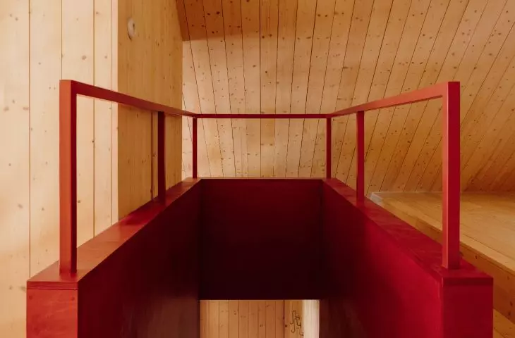 red accents break the subdued color scheme of the interior