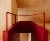 red accents break the subdued color scheme of the interior