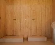 The bedrooms are on an elevated level, and the step leading up to them serves as additional seating 