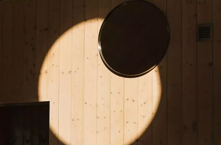 light streaming in through the round window creates an atmospheric interior