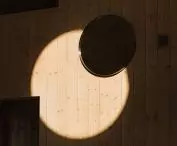 light streaming in through the round window creates an atmospheric interior