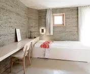 an example of a building located in Europe that was built according to sustainable design principles - using local natural materials, with the participation of local artists and contractors