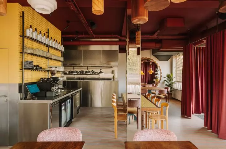 Maroon ceiling and heavy curtain at the entrance add character to the interior
