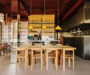 The yellow mosaic contrasts with the brushed steel, which the team used in both the kitchen and bar area