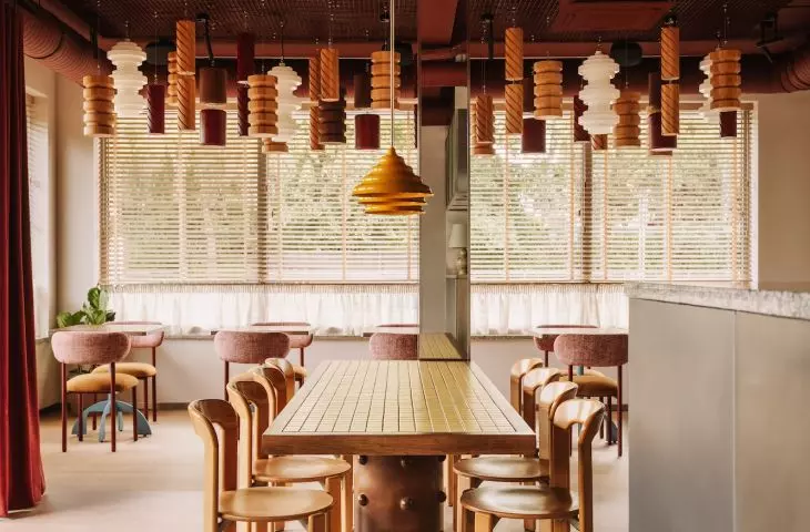opposite the entrance is the largest rectangular table with a mosaic top and a wooden leg with detailing