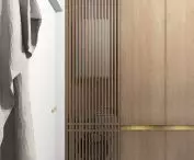 Household appliances are hidden behind wooden slats