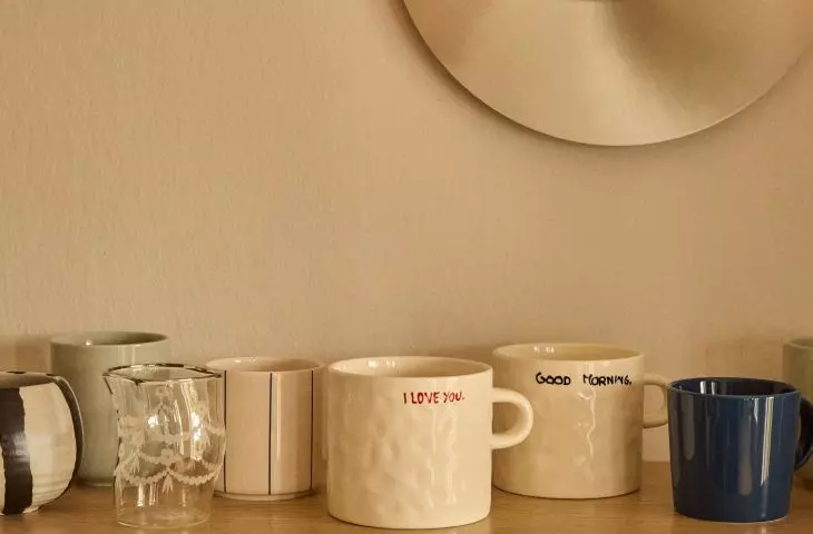 A small section of the kitchen countertop with shelves above it can be a full-fledged coffee area