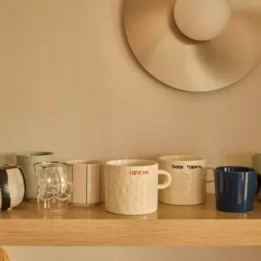 A small section of the kitchen countertop with shelves above it can be a full-fledged coffee area
