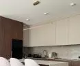 Modern LED Led Line lamp in gold over the kitchen island in an elegant interior