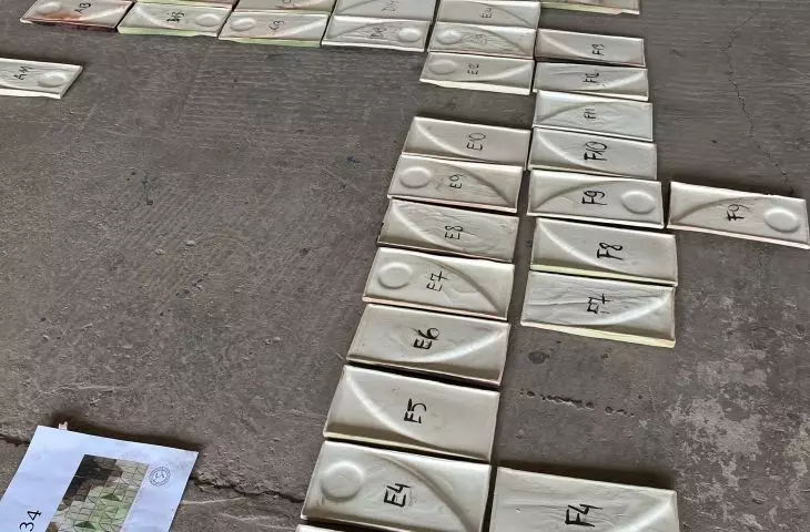 The mosaic consists of hand-laid tiles that form abstract patterns