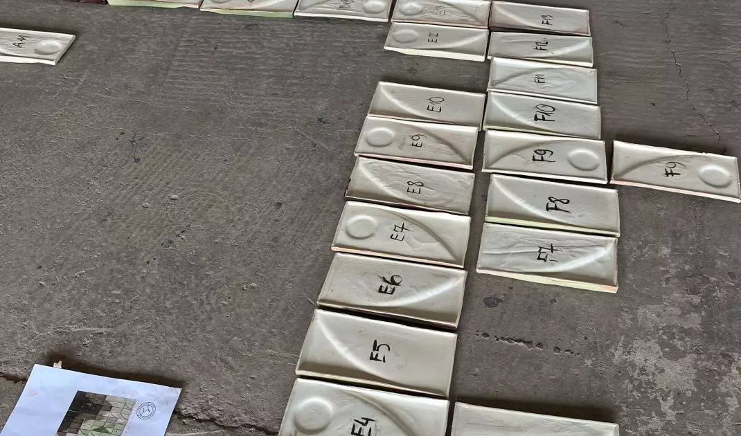 The mosaic consists of hand-laid tiles that form abstract patterns