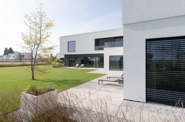 The multigenerational house is characterized by a cuboidal minimalist body with clearly defined functional zones.