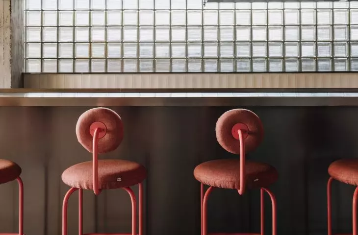Pink-painted welded netting was hung along the bar