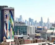 On the wall of the skyscraper is a monumental mural by Felipe Pantone