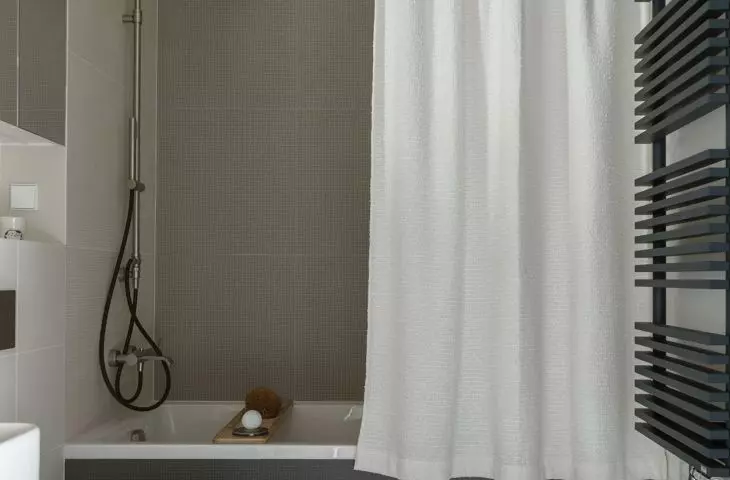 The bathroom is dominated by shades of gray 