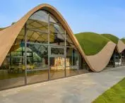 The most distinctive element of the design is the undulating roof - a soft, green surface that appears to grow out of the ground