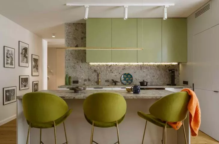 The kitchen is dominated by shades of green 