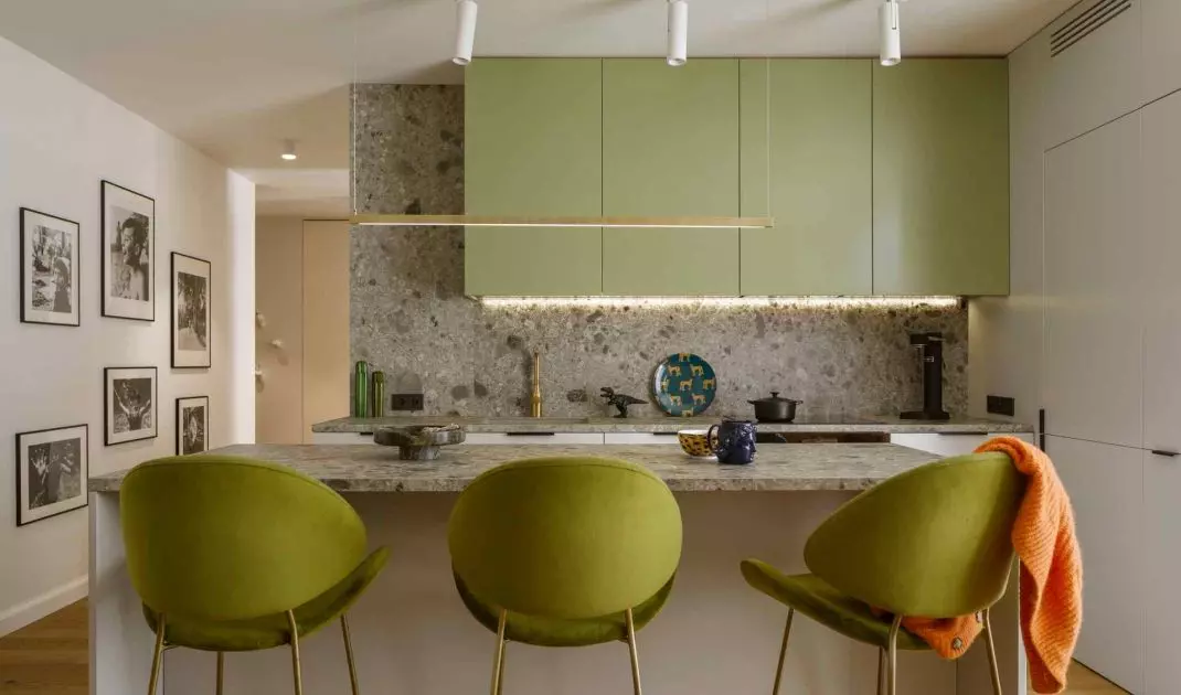 The kitchen is dominated by shades of green 