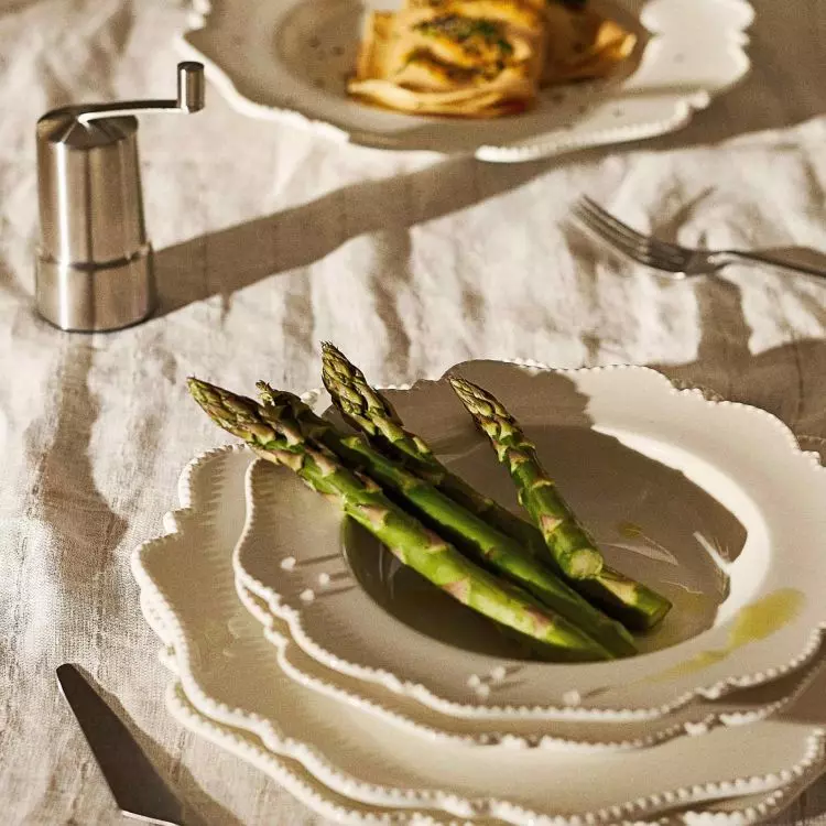 A tablecloth or runner in a muted color organizes the space and provides a neutral background for the tableware