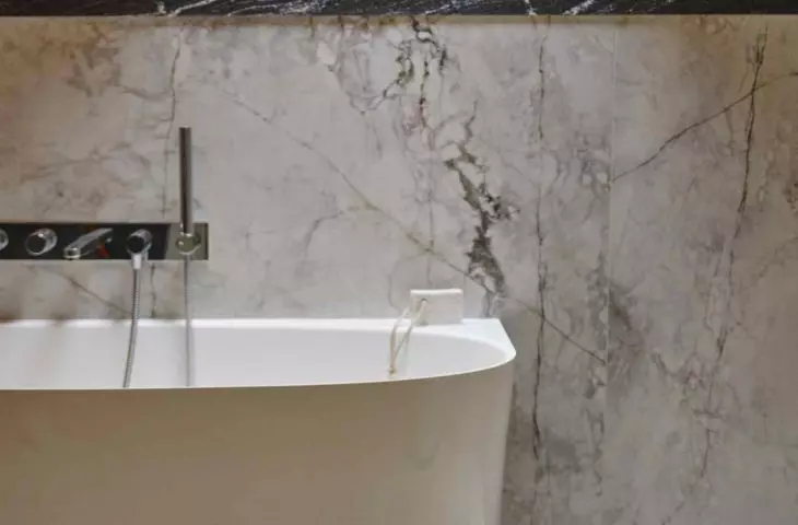 Delicate marble drawing on matte surface adds nobility to the space