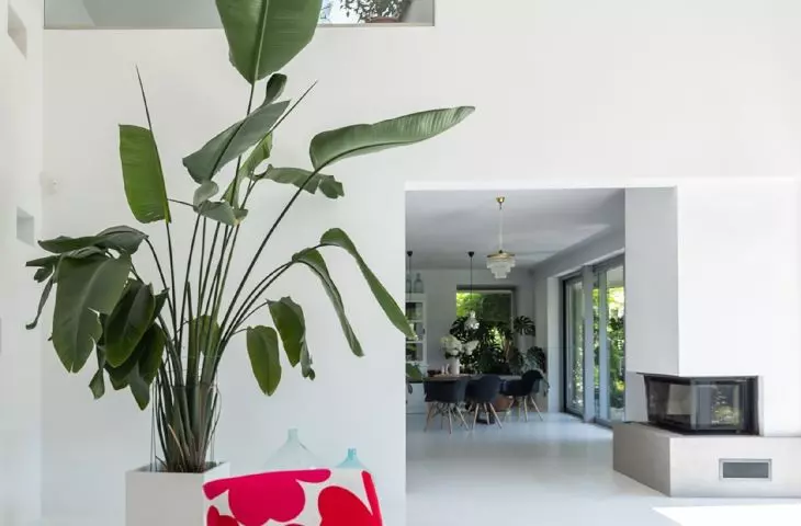 The two-story living room is seamlessly connected to the kitchen and dining room