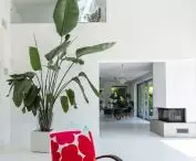 The two-story living room is seamlessly connected to the kitchen and dining room