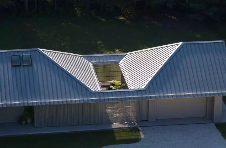 The focal point of the house is the inner garden, hidden under a rectangular opening in the roof - a real 