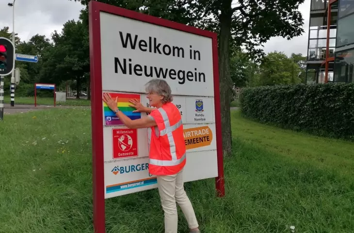 Nieuwegein, na zdjęciu radna Maria Schouten zakleja tęczą Puławy na tablicy z miastami partnerskimi