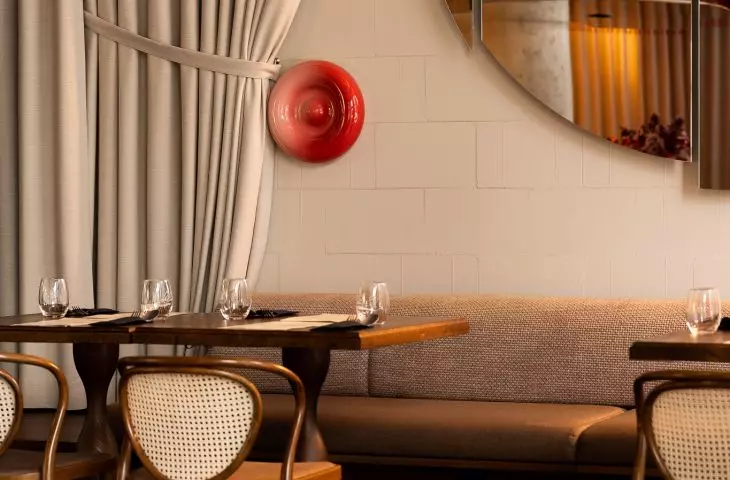 Designers juxtapose raw walls with soft curtains
