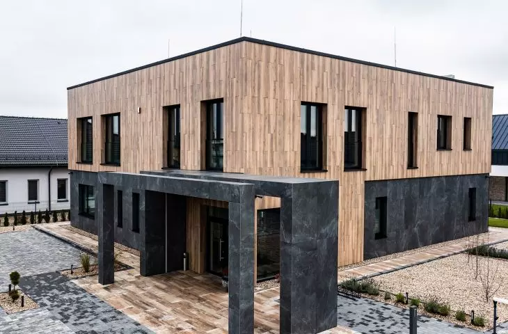 Mountain Ash Almond and Grand Cave Graphite tiles adorn the facade of the Melon Clinic building.