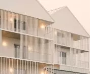 Universal House in Otwock; the element that breaks the ascetic facades are numerous vertical veranda screens
