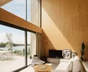 Lakeside home; large glass windows frame lake views