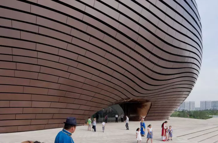 The structure of the Ordos museum is shielded by a system of copper-colored metal panels