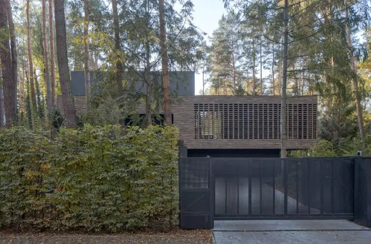 the house is surrounded by forest